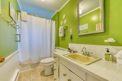 a green bathroom with a sink and a toilet at Cottage by the Sea in Rockaway Beach