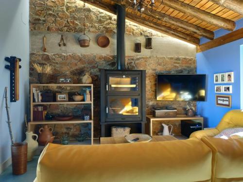 a living room with a couch and a fireplace at Casa Rural Madre del Agua. Finca El Robledillo in Monesterio