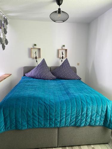 a bedroom with a blue comforter on a bed at Haus Friedel Überlingen am Bodensee in Überlingen