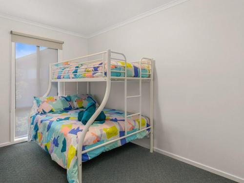 a bedroom with a bunk bed in a room at Waikiki Views in Smiths Beach