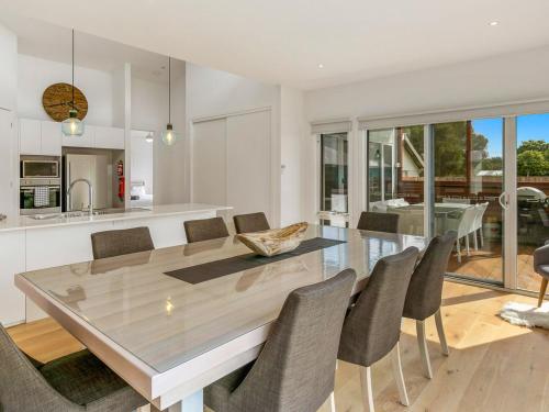a kitchen and dining room with a table and chairs at Absolutely Beach in Cowes