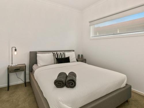 a bedroom with a bed with two towels on it at Absolutely Beach in Cowes