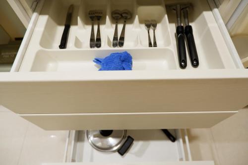 a kitchen sink with a blue towel in it at 42Grand Residence in Bangkok