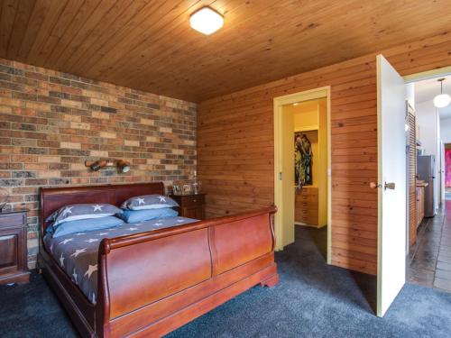 a bedroom with a bed and a brick wall at The View in Rye