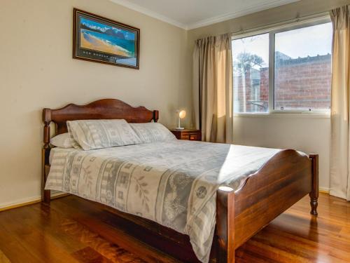 a bedroom with a bed and a large window at Silver Beach in Cowes