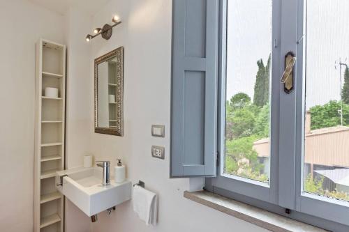 a bathroom with a sink and a window at Casali Marchigiani - Ville vacanza private con piscina in Ostra