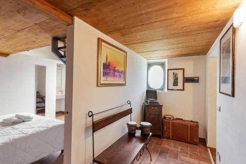 a bedroom with a bed and a wooden ceiling at Casali Marchigiani - Ville vacanza private con piscina in Ostra