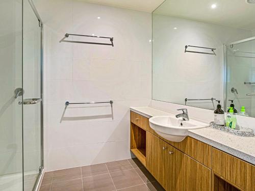 a white bathroom with a sink and a shower at Saltwater Haven in Cowes