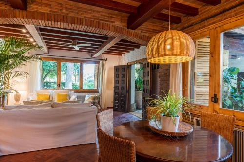 a living room with a table and a dining room at Villa Can Duarry - Barcelona Country House 1 in Premia de Dalt