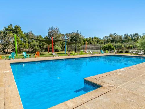 a large blue swimming pool with a playground at Resort Haven in Cowes