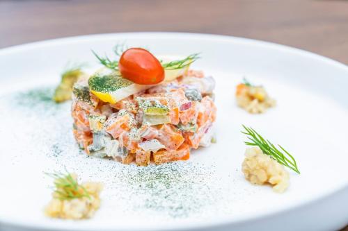 a white plate with a dish of food on a table at Prins Hendrik Texel in Oost