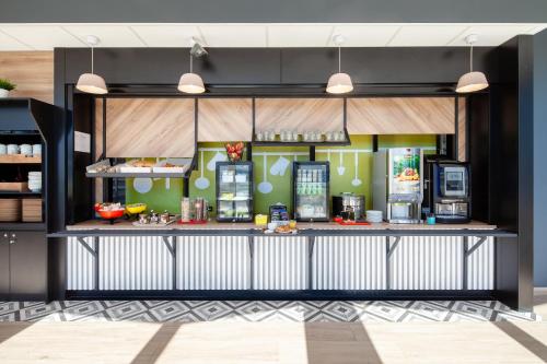a kitchen with a counter with food on it at B&B HOTEL Massy Gare TGV in Massy