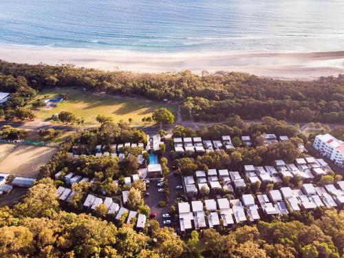 an aerial view of a park next to the ocean at Allure Stradbroke Resort in Point Lookout