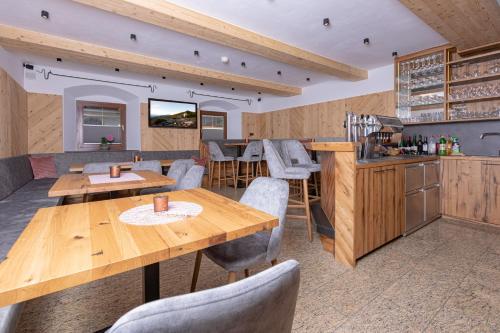 a dining room with wooden tables and chairs at Gasthof Aigner *** in Fügen