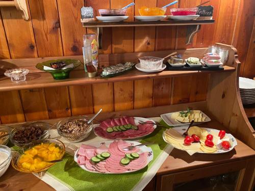a table with many plates of food on it at Pension Glückauf in Kurort Oberwiesenthal