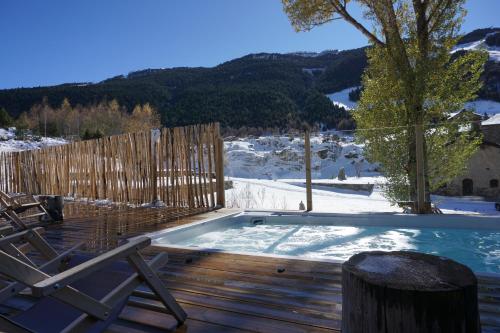a hot tub on a deck in the snow at Mountain Hostel Tarter in El Tarter