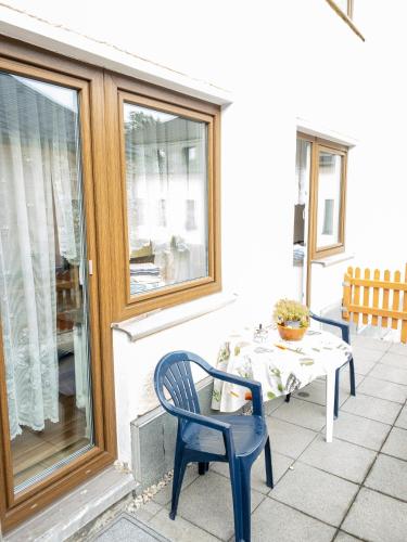 a table and chairs on a patio with a table and a table and chairs at Pension Glückauf in Kurort Oberwiesenthal