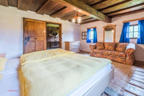 a bedroom with a bed and a couch at Almliesl ABTE-395 in Abtenau