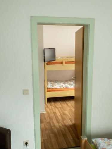a room with a bedroom with a bunk bed and a mirror at Pension Glückauf in Kurort Oberwiesenthal