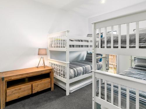 a bedroom with two bunk beds and a desk at The Mansion in Cowes