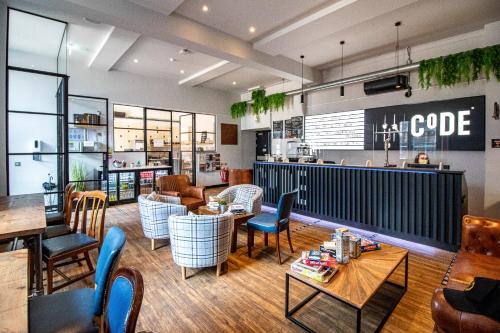 a restaurant with tables and chairs and a bar at CoDE Pod – The CoURT - Edinburgh in Edinburgh
