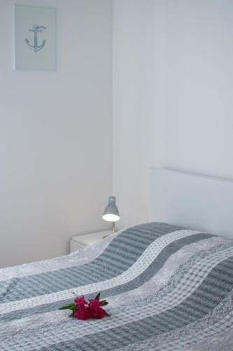 a bedroom with a bed with a flower on it at Villas Faro in Bašanija