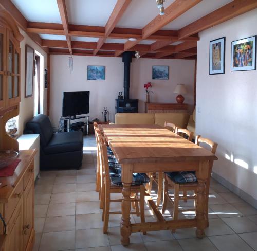 a living room with a wooden table and a couch at Zeepark Zeewind in Bredene