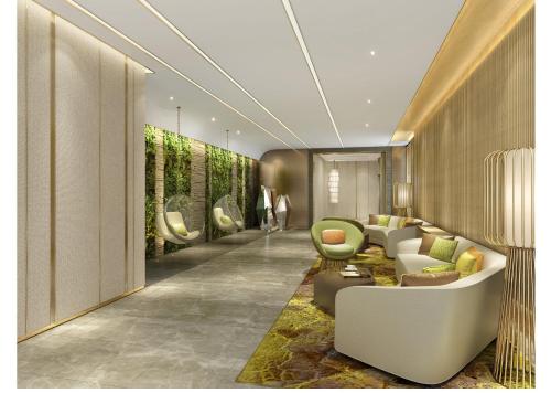 a living room with a white couch and chairs at Holiday Inn Nanjing Harbour by IHG in Nanjing