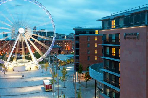 a ferris wheel in the middle of a city at Staybridge Suites Liverpool by IHG in Liverpool