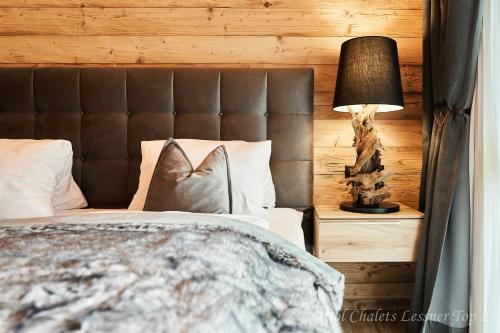 a bedroom with a bed and a lamp on a night stand at Chalet Leßner in Leutasch