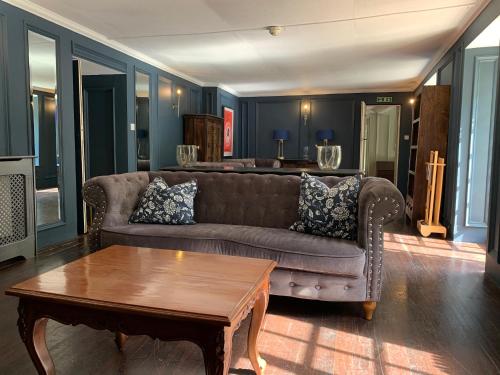 a living room with a couch and a coffee table at Boscundle Manor in St Austell