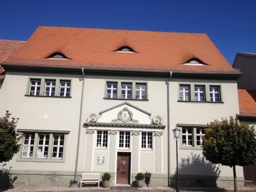 a large white building with a red roof at Altes Standesamt Weißensee in Weißensee