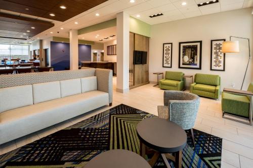 a lobby of a hospital with a couch and chairs at Holiday Inn Express - North Augusta South Carolina by IHG in North Augusta