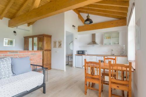 una cucina e un soggiorno con divano e tavolo di Apartamentos Rurales Las Garzas de Oyambre a San Vicente de la Barquera