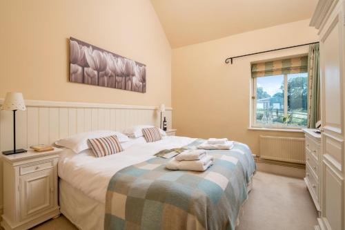 a bedroom with two beds and a window at Little Walk Cottage in Grimsby