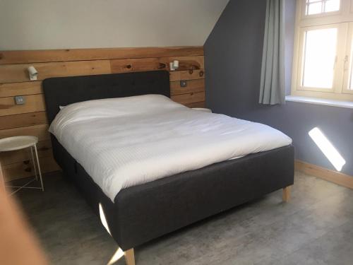 uma cama num quarto com uma parede azul em The Old Coach House em Polesworth