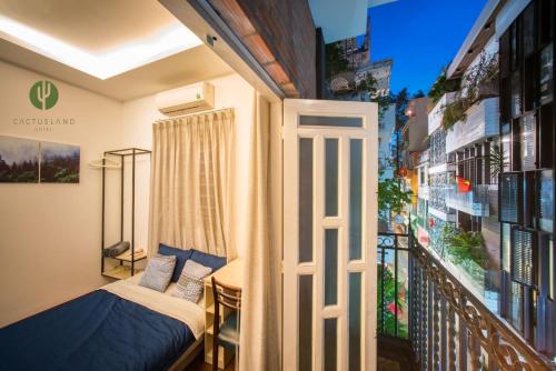 a small balcony with a bed and a window at Cactusland Homestay - Tran Hung Dao in Ho Chi Minh City