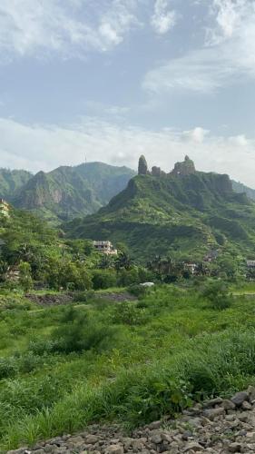 a green field with mountains in the background at B&B "Villa Alegria", Tarrafal in Tarrafal