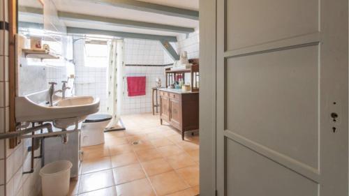 a bathroom with a sink and a toilet in it at Charming 125 m2 apartment in historic center Middelburg in Middelburg