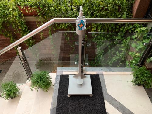 a glass table with a bottle on top of it at La Residence in Gurgaon