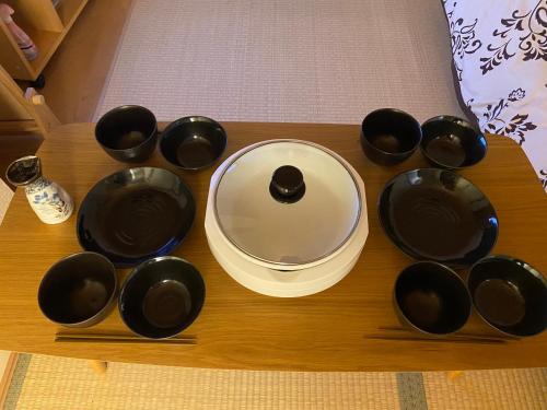 a group of black cups and a plate on a table at Hotel EL Shinjuku 6 in Tokyo