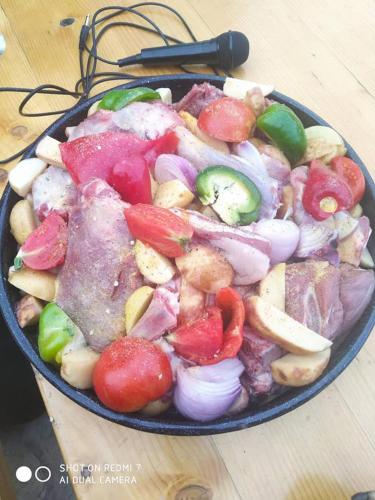 a pan filled with vegetables on top of a table at Krka Fairytale village in Rupe
