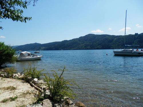 two boats are docked in the water on a lake at Ferienhaus Maier in Lind