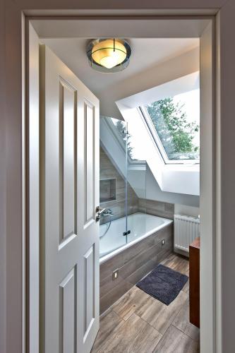 a bathroom with a tub and a skylight at Ferienwohnung Dammerstorf in Dettmannsdorf