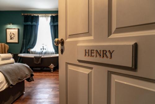 a bathroom with a door with the word henry on it at The Coach and Horses in Clitheroe