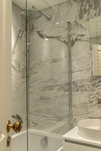 a bathroom with a shower with a glass door at The Coach and Horses in Clitheroe