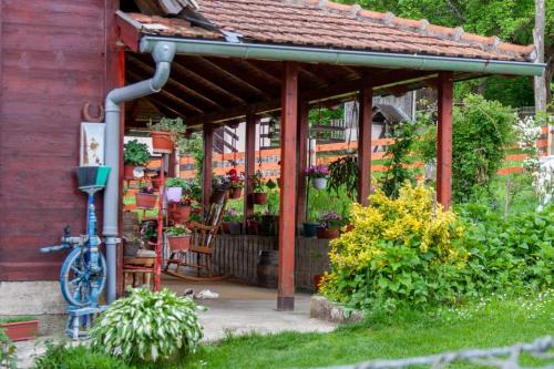 a garden pavilion with a bike parked in front of it at Apartmani Beslic in Kremna