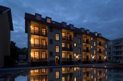 a building with a pool in front of it at Boardinghouse alte Spinnerei in Offenburg