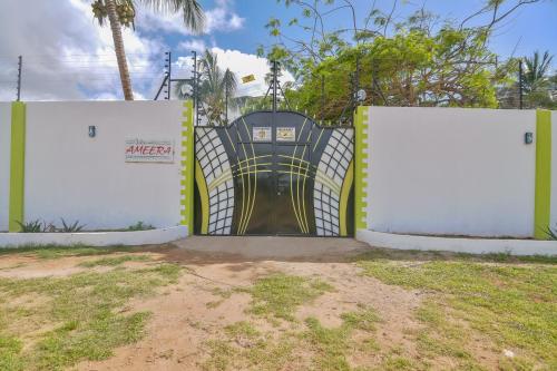 a gate with a door in the middle at Villa Ameera Malindi in Malindi