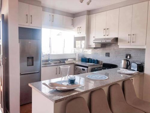 a kitchen with a counter with a wine glass on it at Newly Renovated 2 bed Apartment - Kingston Estate in Ballito